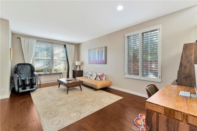 living area featuring dark wood-style flooring and baseboards