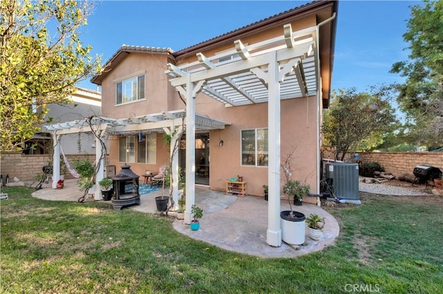 back of property with stucco siding, central AC, a lawn, and a pergola