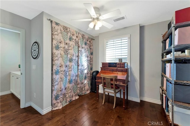 office featuring dark wood-style flooring, visible vents, ceiling fan, and baseboards