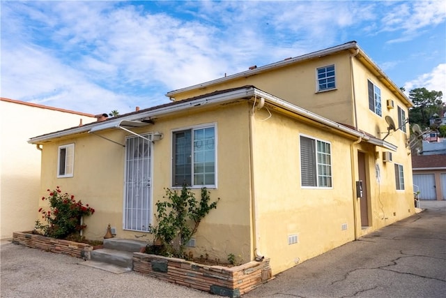 view of side of property featuring crawl space and stucco siding