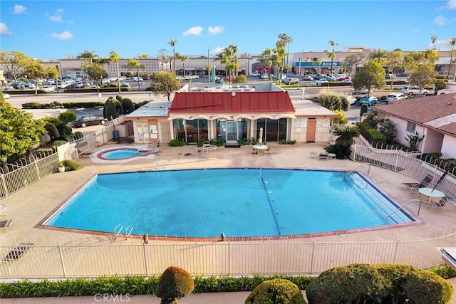 view of pool with a patio area and a hot tub