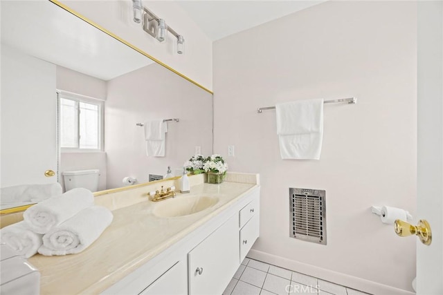 bathroom with vanity, toilet, and tile patterned floors