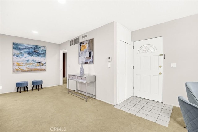 entryway featuring light colored carpet