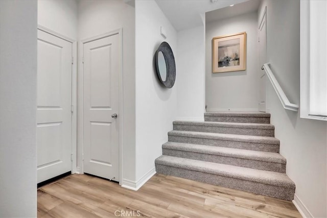 staircase with hardwood / wood-style floors