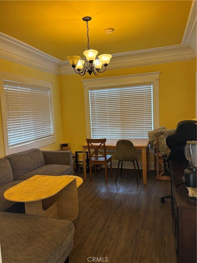 dining area with ornamental molding, dark wood-style flooring, and a notable chandelier