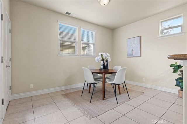 dining area featuring visible vents, light tile patterned floors, and baseboards