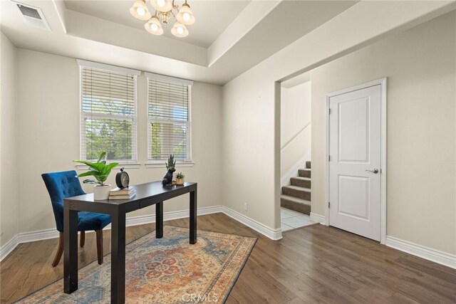 home office with visible vents, a notable chandelier, and baseboards
