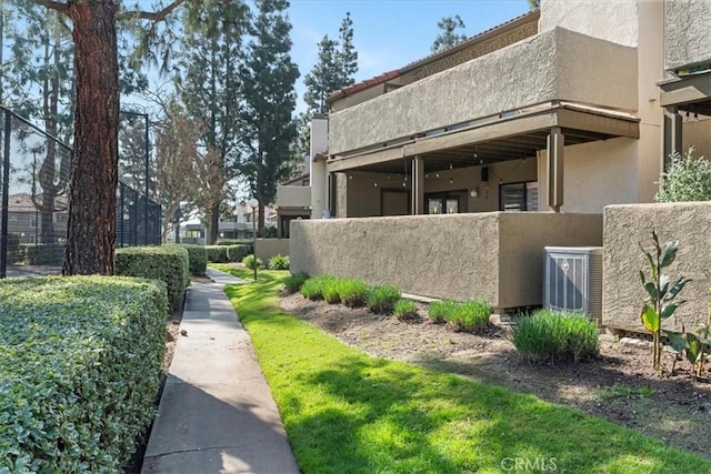 view of property exterior featuring cooling unit and stucco siding