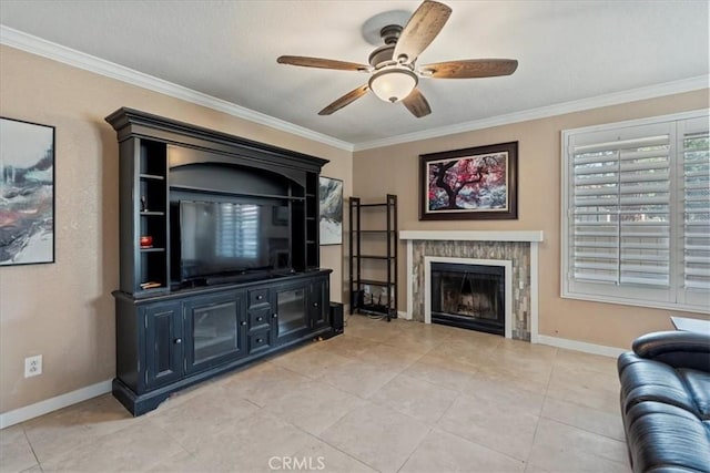 living room featuring baseboards, a fireplace, ceiling fan, and crown molding