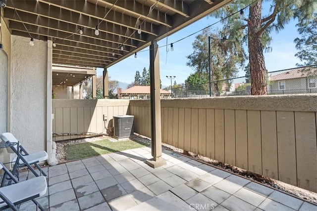 view of patio featuring central air condition unit and fence