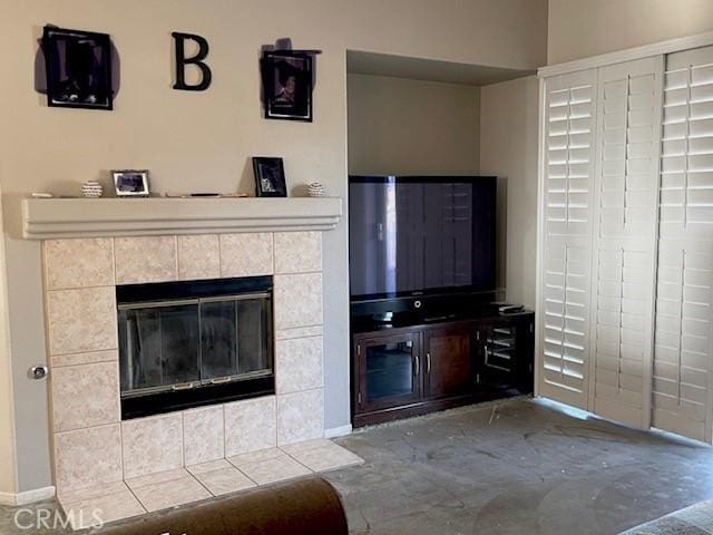 unfurnished living room featuring a tiled fireplace