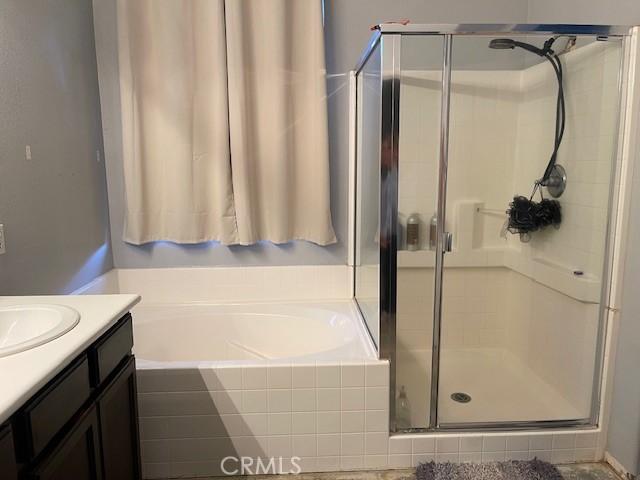 bathroom with separate shower and tub and vanity