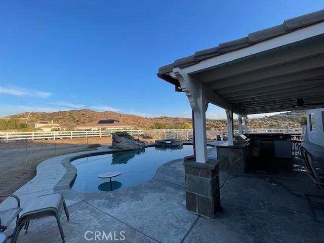 view of patio / terrace featuring a mountain view and exterior bar