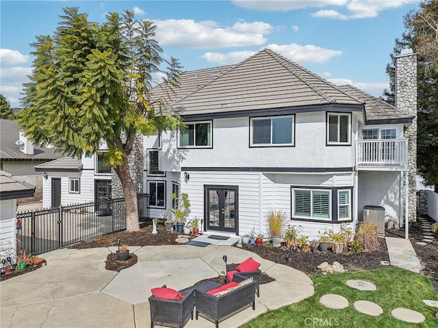 view of front of house with french doors, an outdoor living space, and a patio area