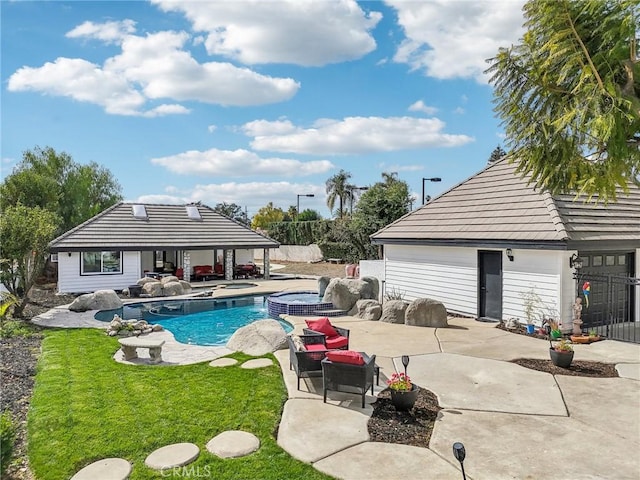 view of pool with an outdoor structure, an in ground hot tub, a lawn, and a patio area