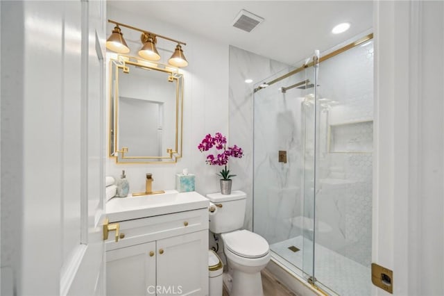 bathroom with vanity, toilet, and walk in shower