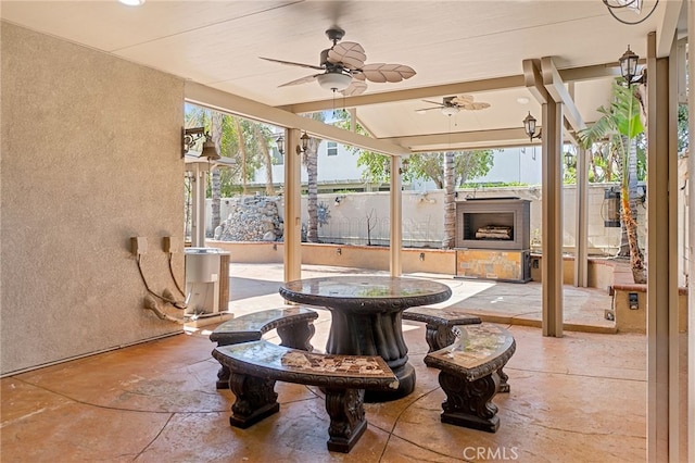 interior space with ceiling fan and fence