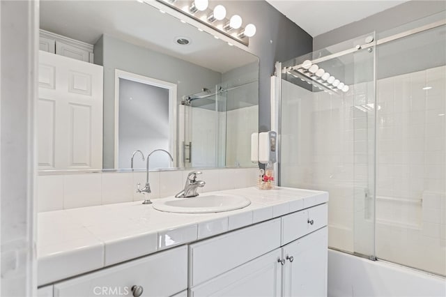 full bath featuring combined bath / shower with glass door and vanity