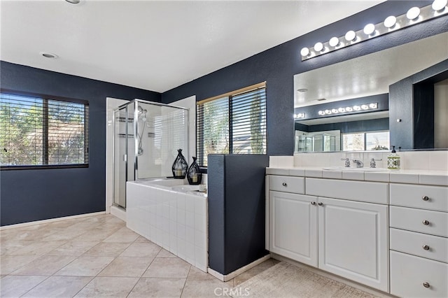 full bath featuring a garden tub, plenty of natural light, a shower stall, and vanity