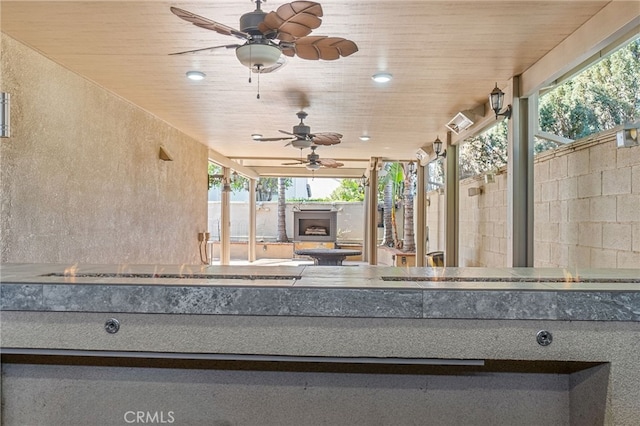 view of patio with fence and a ceiling fan