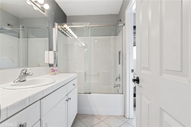 full bath with shower / bath combination with glass door, tile patterned flooring, and vanity