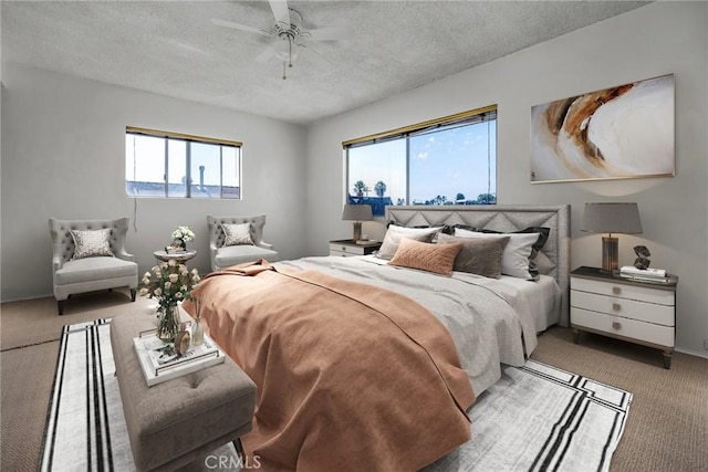 bedroom with a textured ceiling, light carpet, and ceiling fan