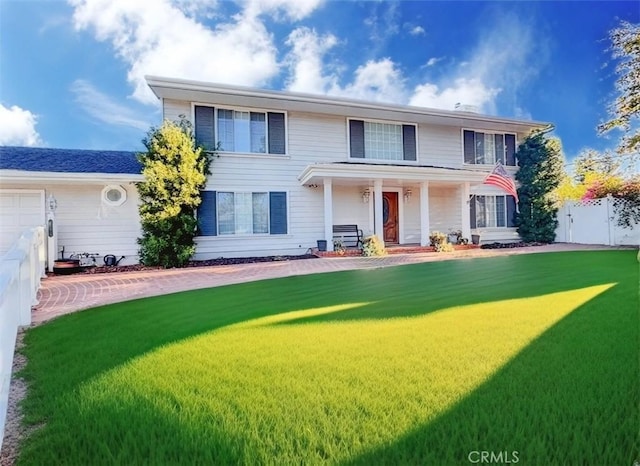 view of front of property featuring covered porch and a front yard