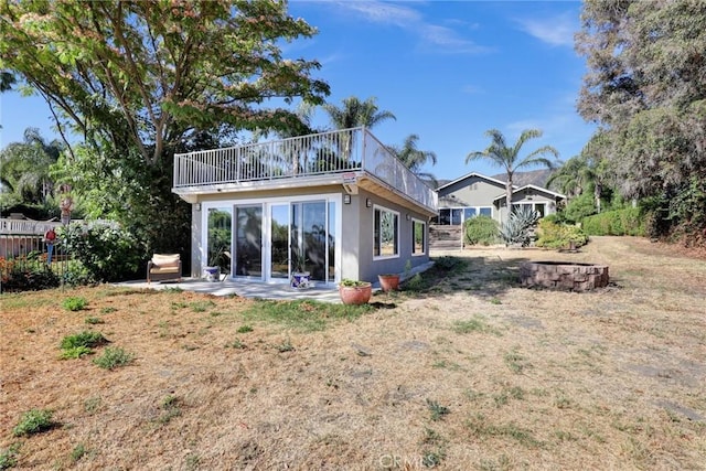 back of property with a patio and a lawn