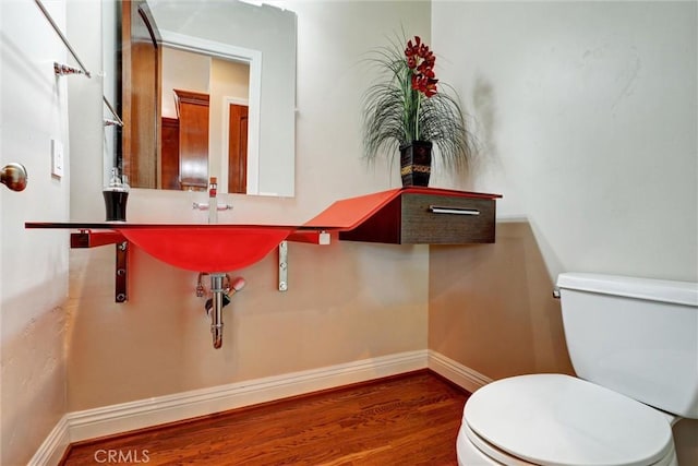 bathroom featuring toilet and hardwood / wood-style flooring