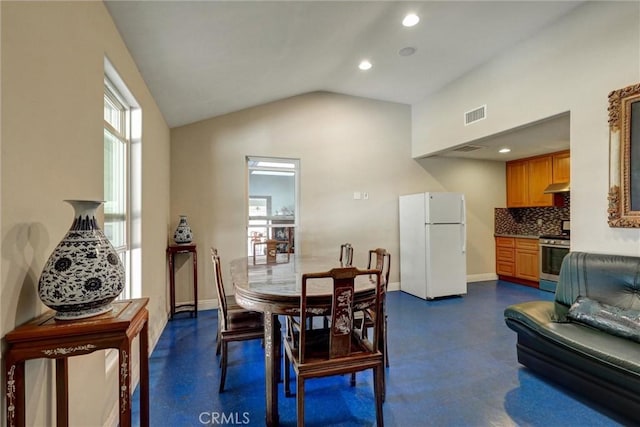 dining area featuring vaulted ceiling