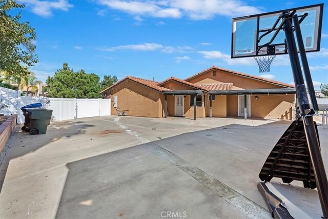 exterior space featuring basketball court and fence