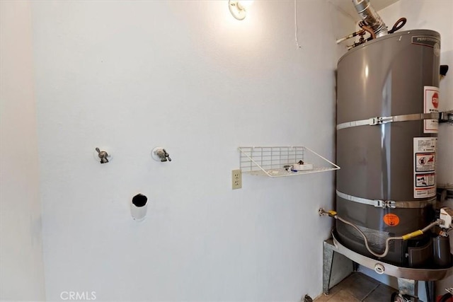 utility room featuring water heater