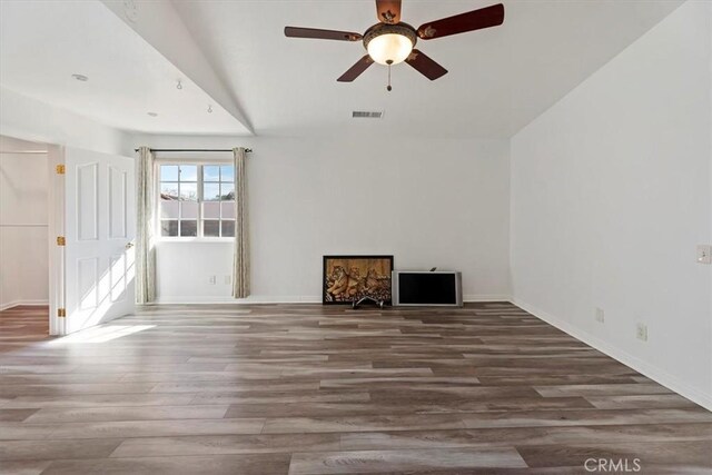 unfurnished room with visible vents, ceiling fan, baseboards, and wood finished floors