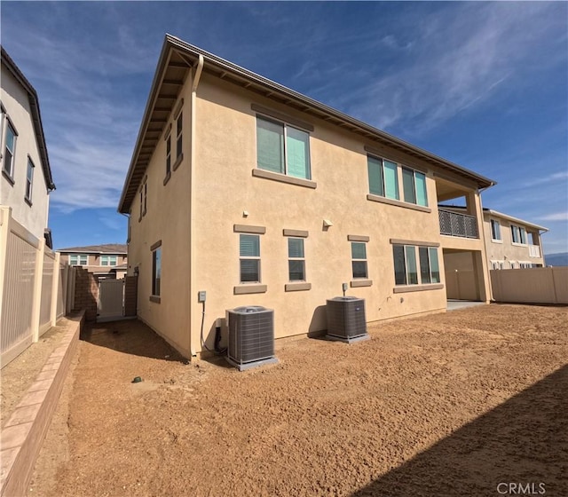 back of property featuring central AC