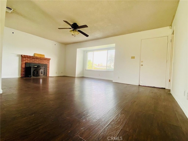 unfurnished living room featuring a textured ceiling, dark hardwood / wood-style floors, and ceiling fan