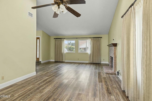 unfurnished living room with visible vents, baseboards, wood finished floors, and a fireplace