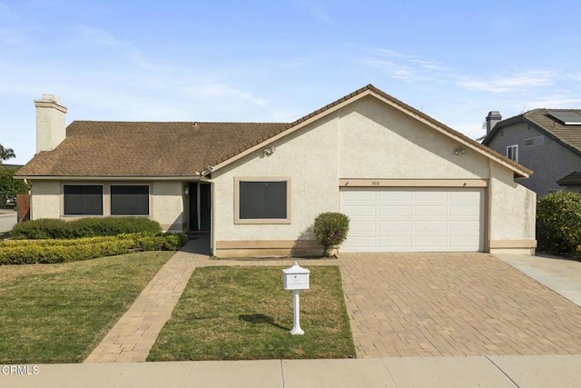 ranch-style house with stucco siding, decorative driveway, a garage, and a front yard