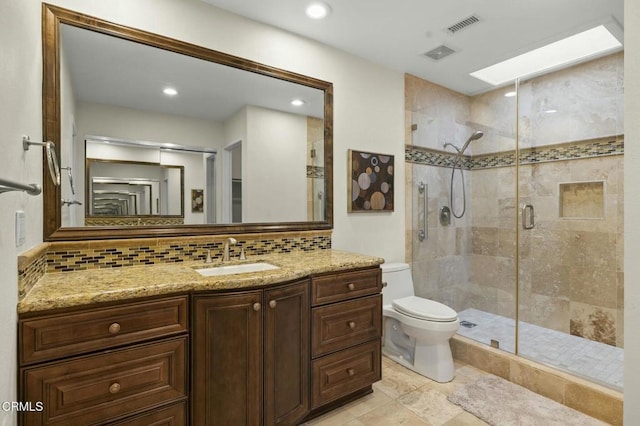 bathroom featuring vanity, visible vents, a shower stall, toilet, and backsplash