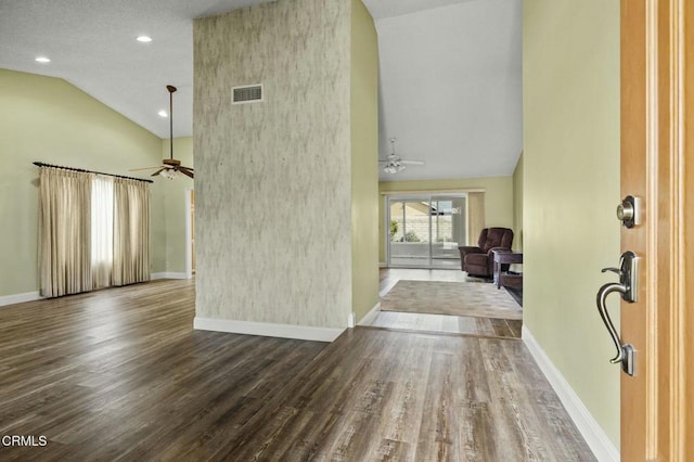 interior space with visible vents, a ceiling fan, baseboards, and wood finished floors