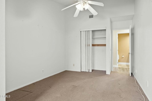 unfurnished bedroom featuring a closet, visible vents, a ceiling fan, and carpet