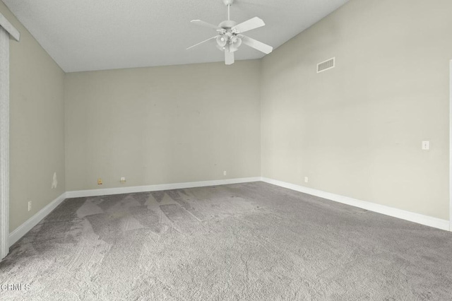 unfurnished room featuring visible vents, baseboards, carpet, and a ceiling fan