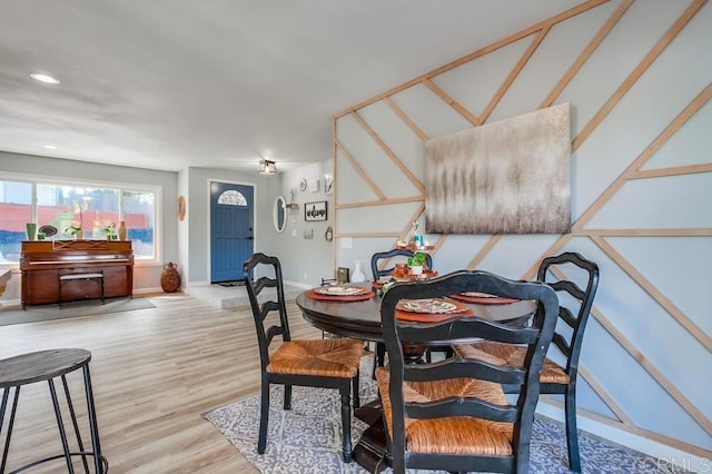 dining space with wood-type flooring