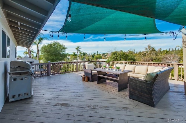 wooden terrace featuring outdoor lounge area and grilling area