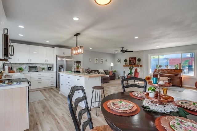 dining room featuring light hardwood / wood-style floors and ceiling fan