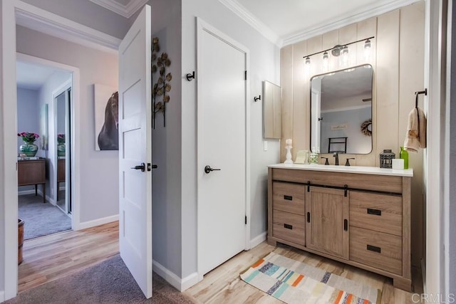 bathroom featuring vanity, crown molding, and hardwood / wood-style floors