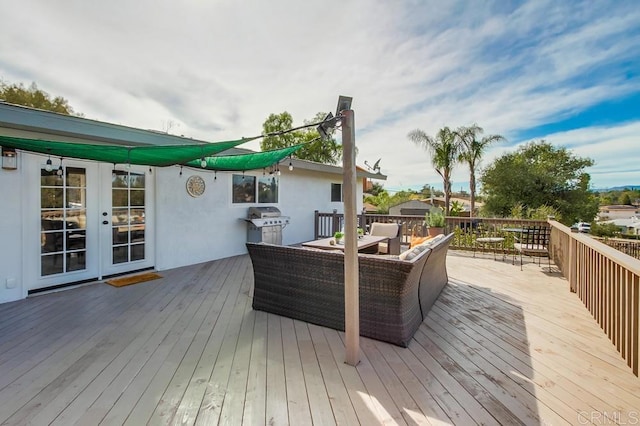 deck featuring an outdoor hangout area, area for grilling, and french doors