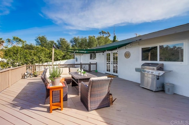 wooden terrace featuring a grill and french doors