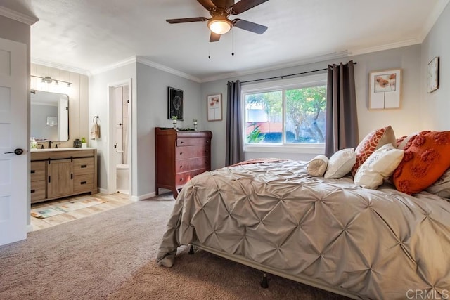 bedroom featuring light colored carpet, ensuite bath, sink, ornamental molding, and ceiling fan