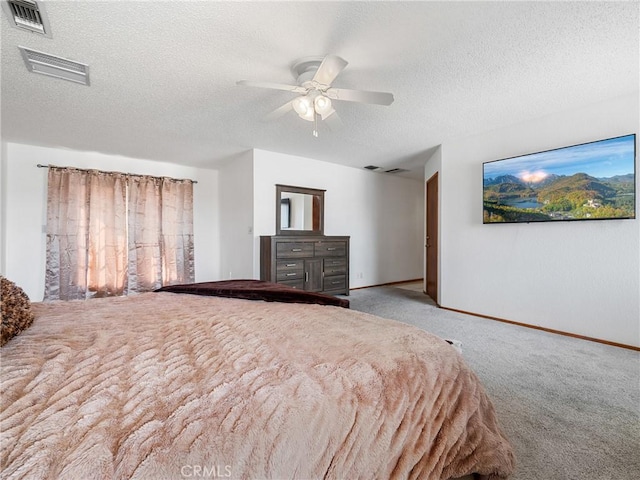 unfurnished bedroom featuring ceiling fan, light carpet, and a textured ceiling