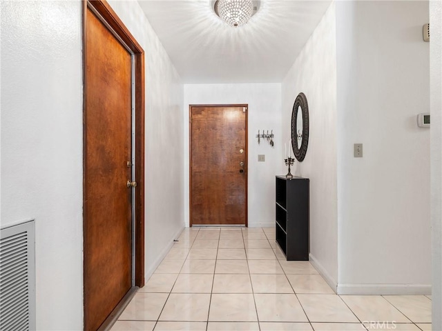 corridor featuring light tile patterned floors